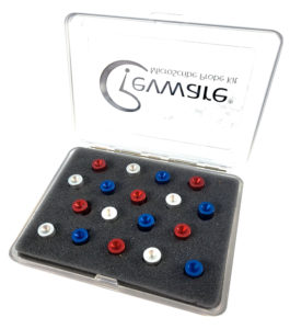A clear case with the top open, charcoal gray foam insert and eighteen small aluminum alignment divots in red, silver, and blue