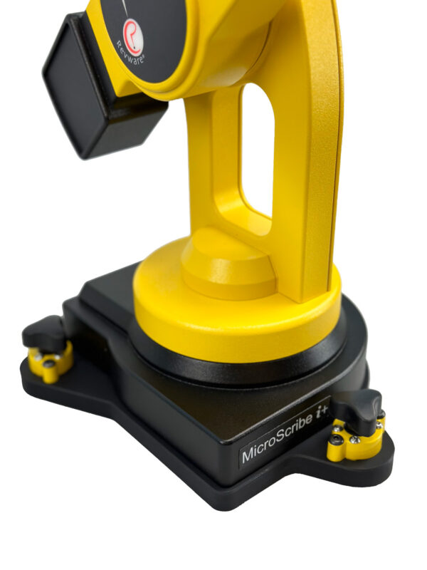 Closeup of a yellow and black MicroScribe i Plus portable 3D scanner arm base attached to a black triangular mounting plate with three yellow and black magnetic locks.