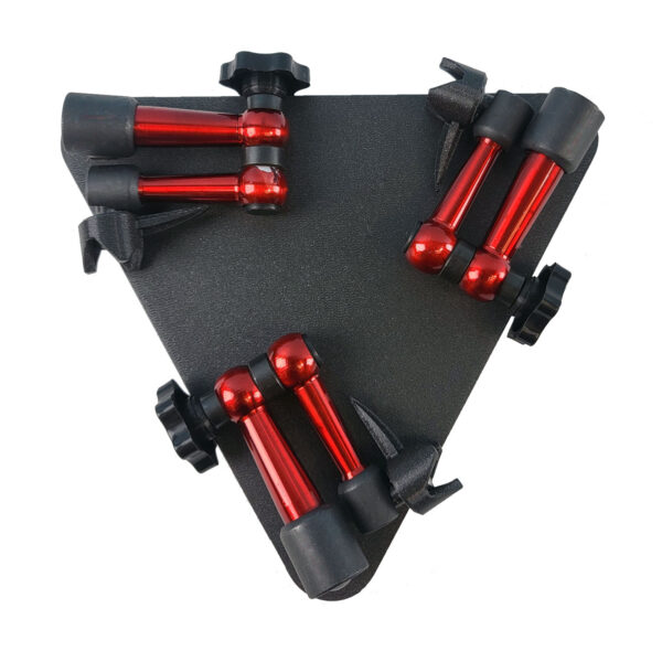 A three-armed specimen stand folded flat for compact storage. The stand has a black triangular base and three red metal arms with black pointed tips.